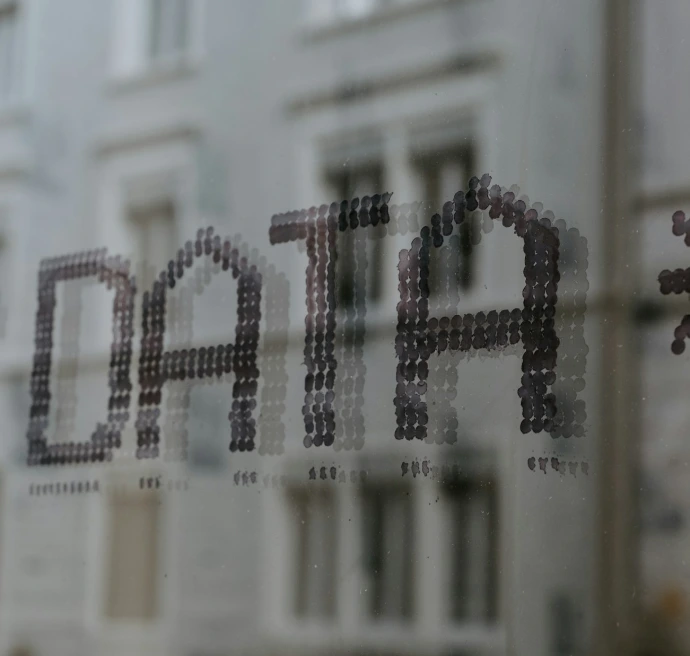 a close up of a window with a building in the background